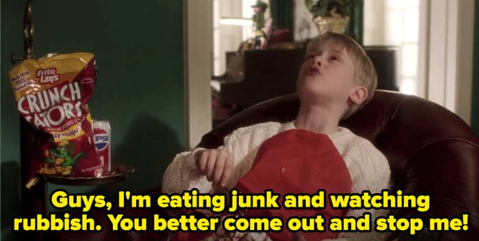 Kevin from "Home Alone" eating junk food while watching a gangster movie