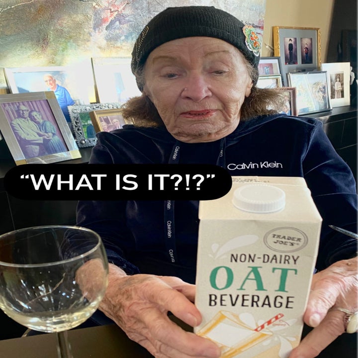 My grandma inspecting a carton of non-dairy oat beverage.