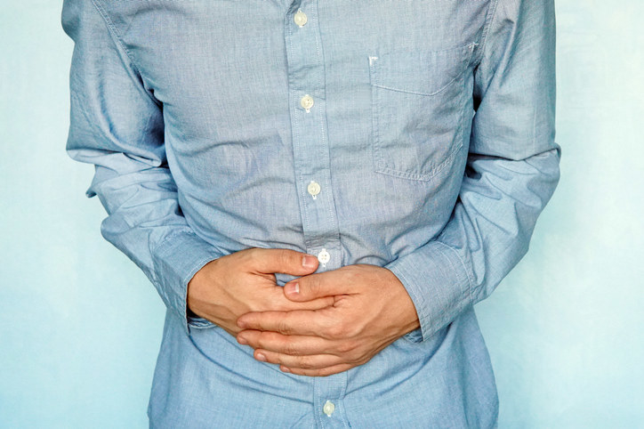 Businessman holding his stomach in pain