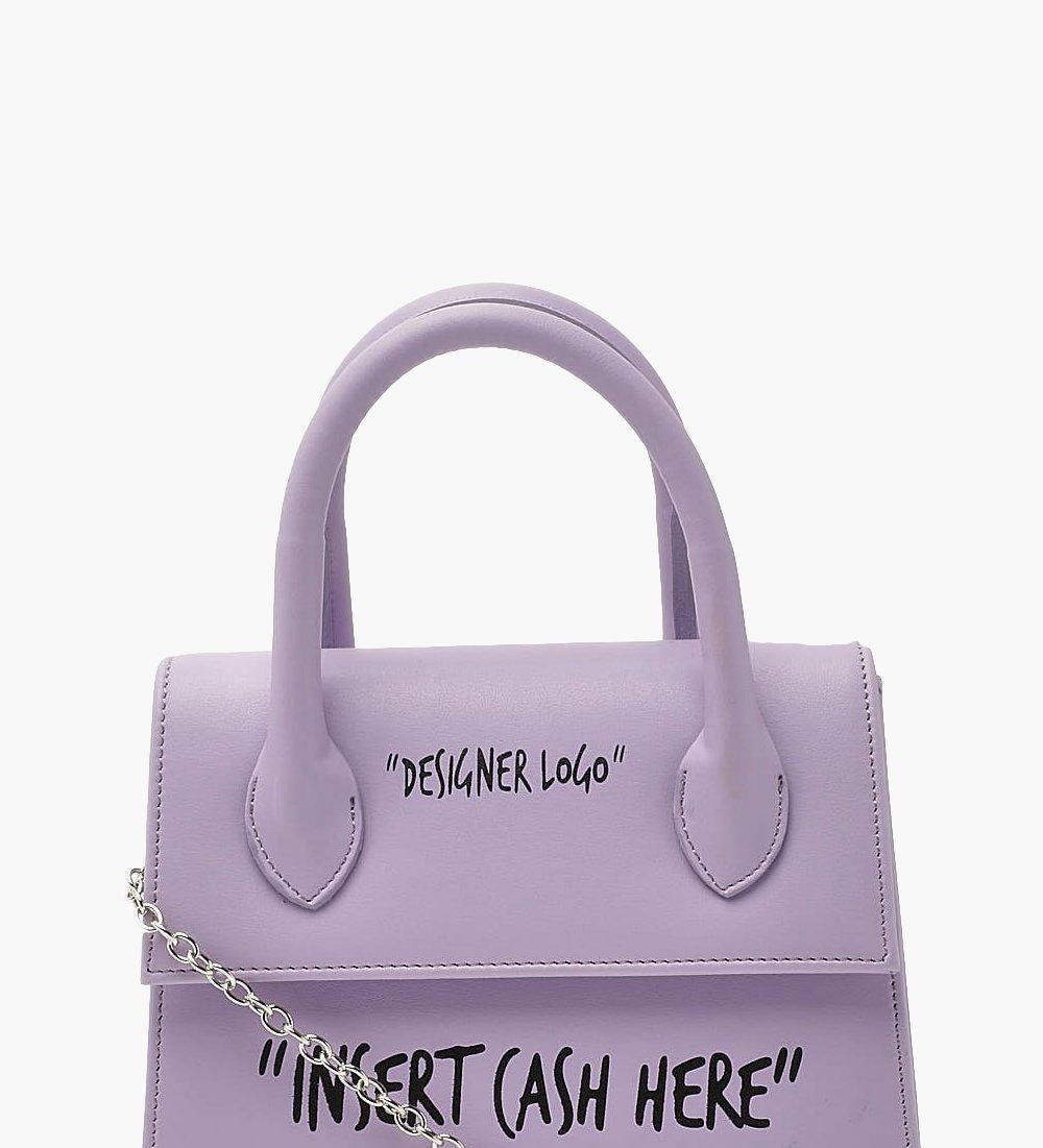 purple purse that sayd &quot;designer logo&quot; and &quot;insert cash here&quot; in black letters 