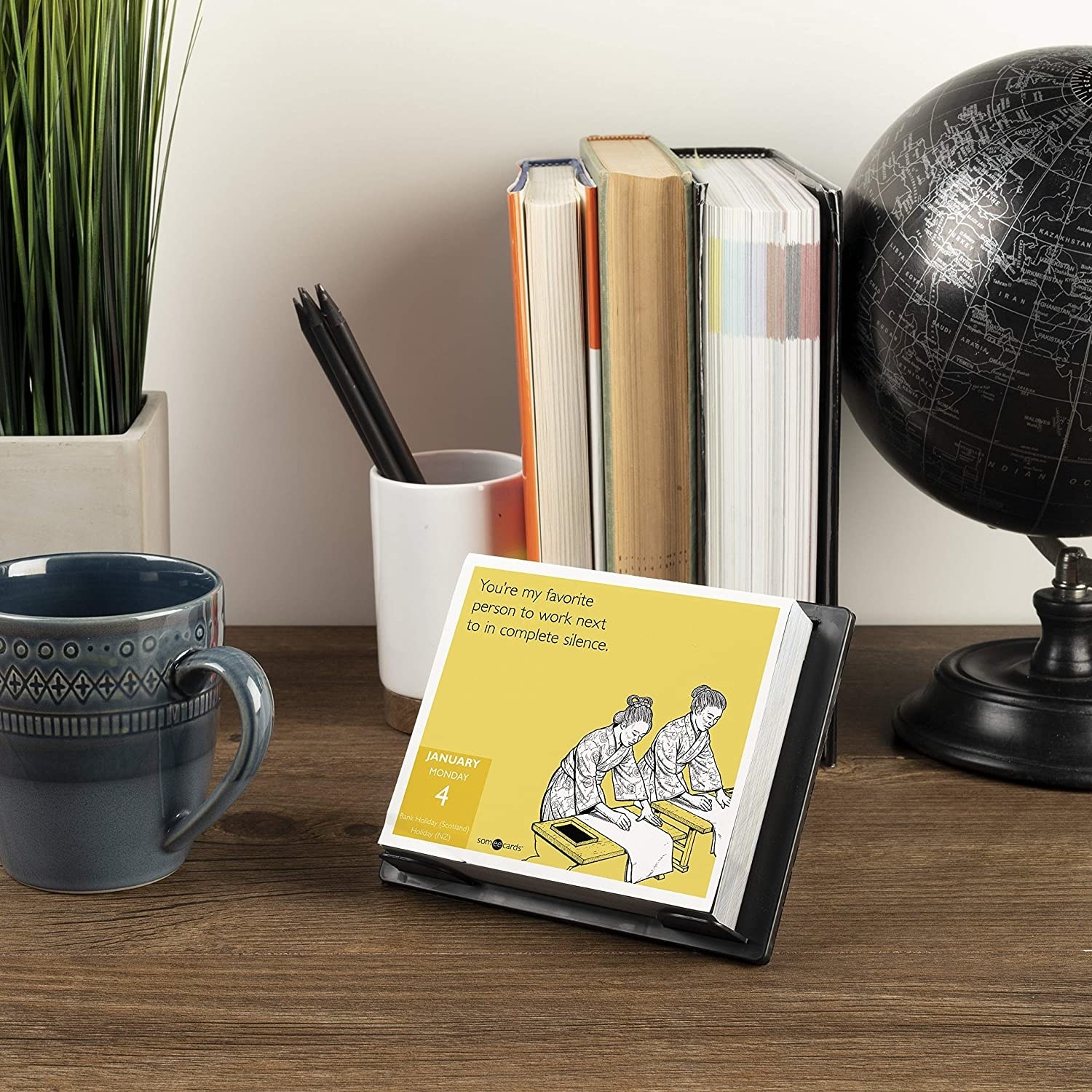 A daily calendar with a cartoon of people working that says "you're my favorite person to work next to in complete silence" 