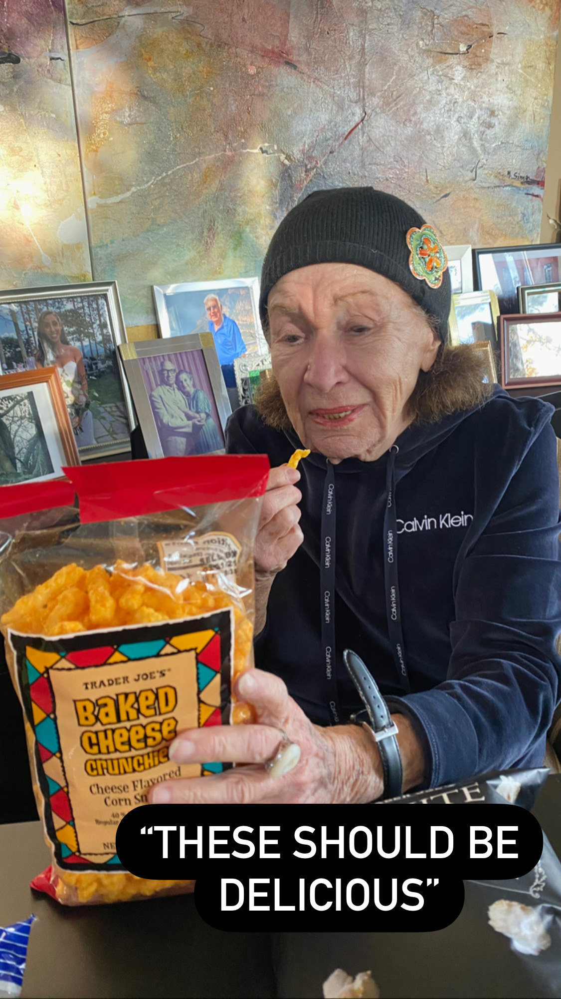 My grandma inspecting a bag of baked cheese crunchies.