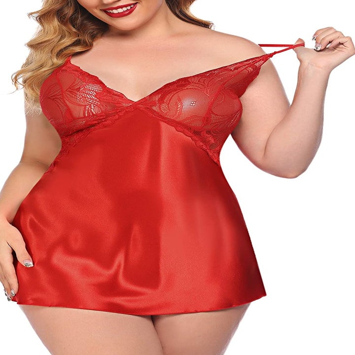 A model in the short chemise with spaghetti straps, sheer lace cups, and a satin bodice in red
