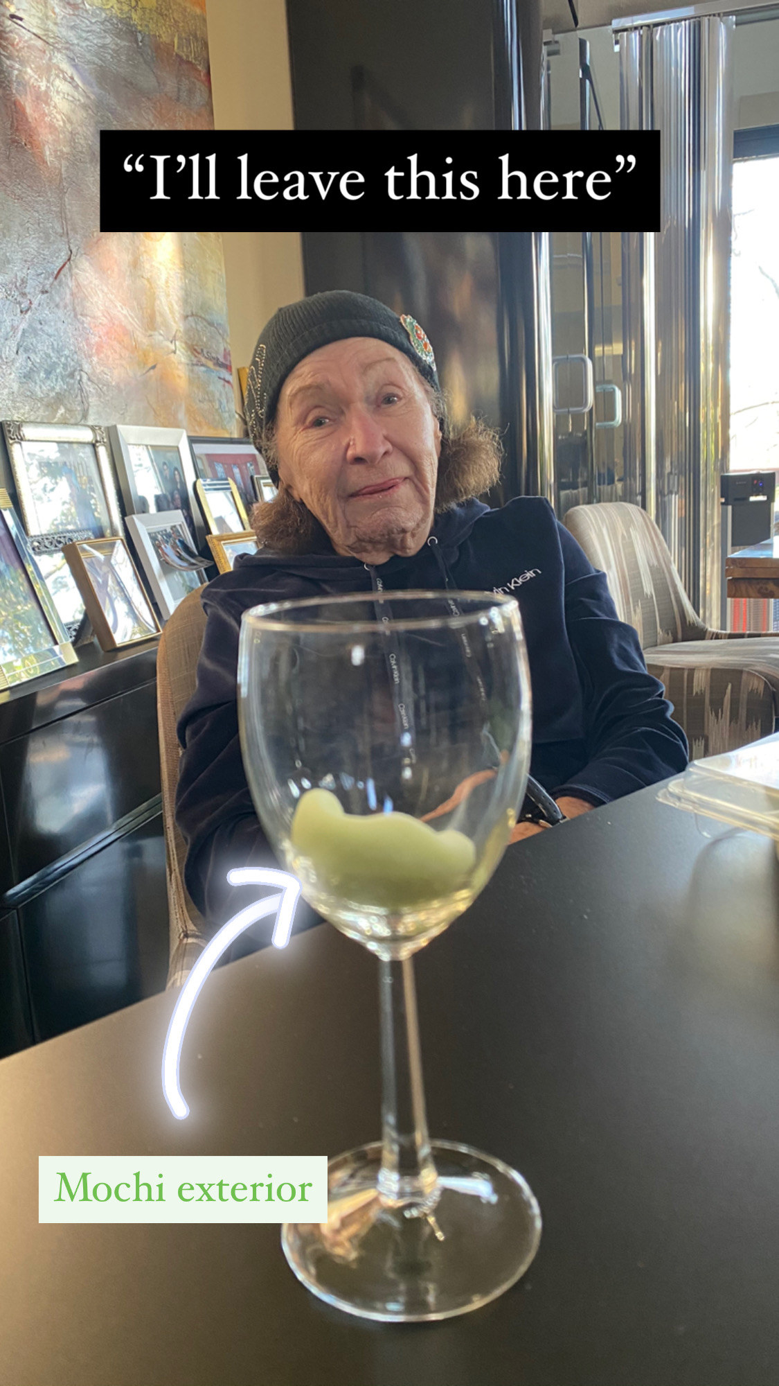 My grandma sitting with a wineglass filled with the mochi shell.