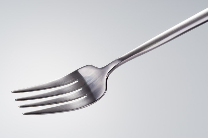 Side Shot of a Silver Colored Fork Against White Background.