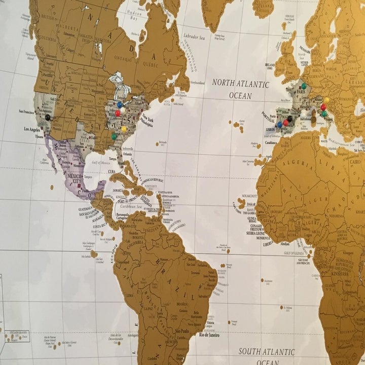 The gold scratch off map with some countries scratched off