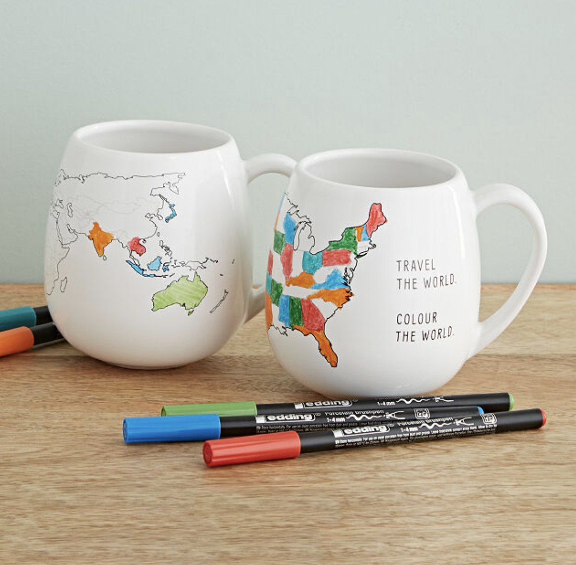 two mugs, one with a world map you can color and one with a map of the US 