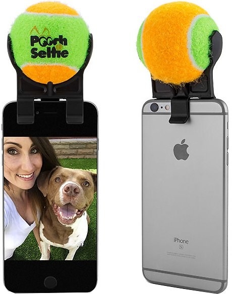 An iPhone with an attachment that hold a tennis ball on top of it