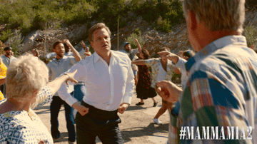 Gif of Colin Firth in Mamma Mia 2 pointing while dancing