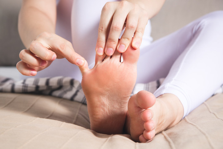 Woman&#x27;s leg hurts, pain in the foot, massage of female feet at home