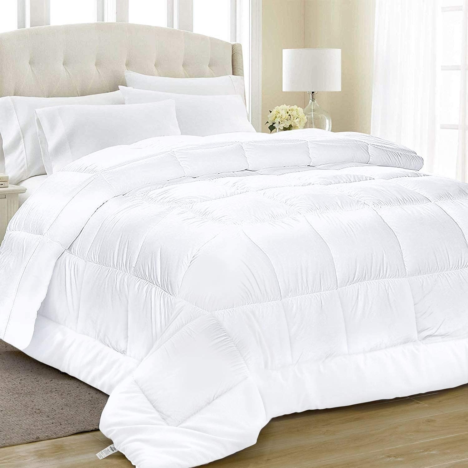 The large comforter draped over a bed