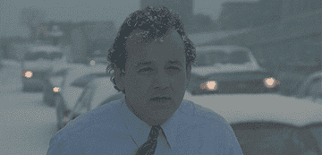 GIF of Bill Murray from Groundhog Day saying&quot;What blizzas? It&#x27;s a couple of flakes&quot;