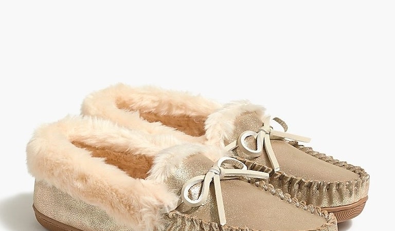 the slippers in gold faux leather with the shearling lining and faux leather bows