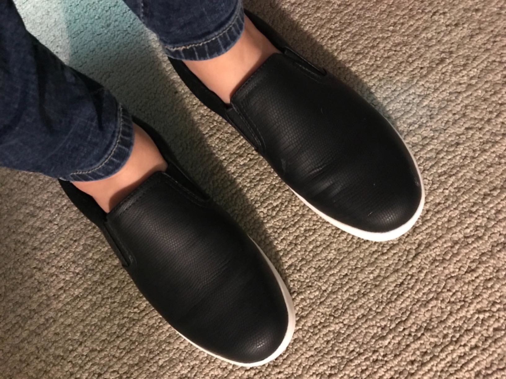 Reviewer wearing the slip-on sneakers in black