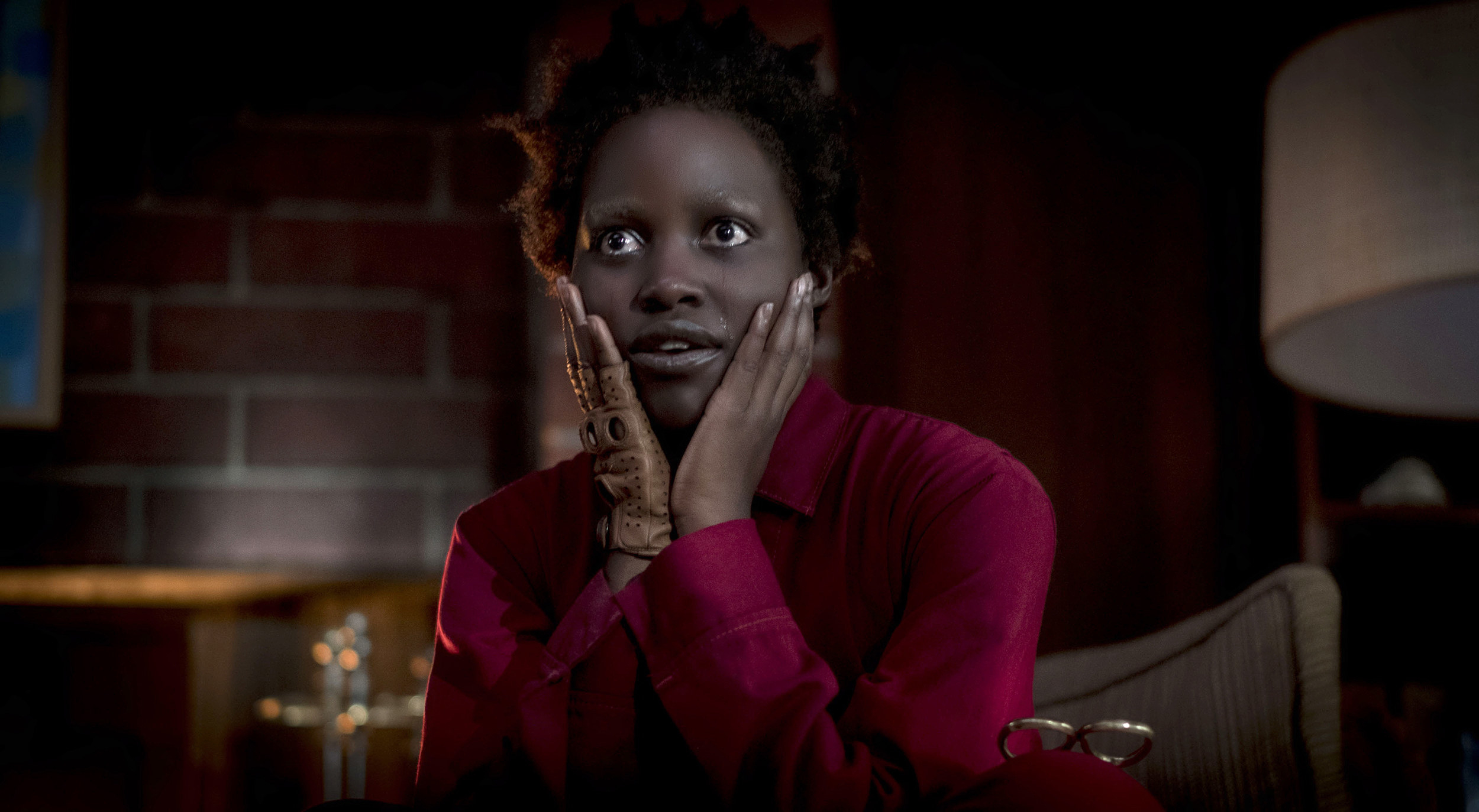 Lupita Nyong&#x27;o as Adelaide Wilson/Red in &quot;Us&quot;; she is sitting down, with her hands touching her face