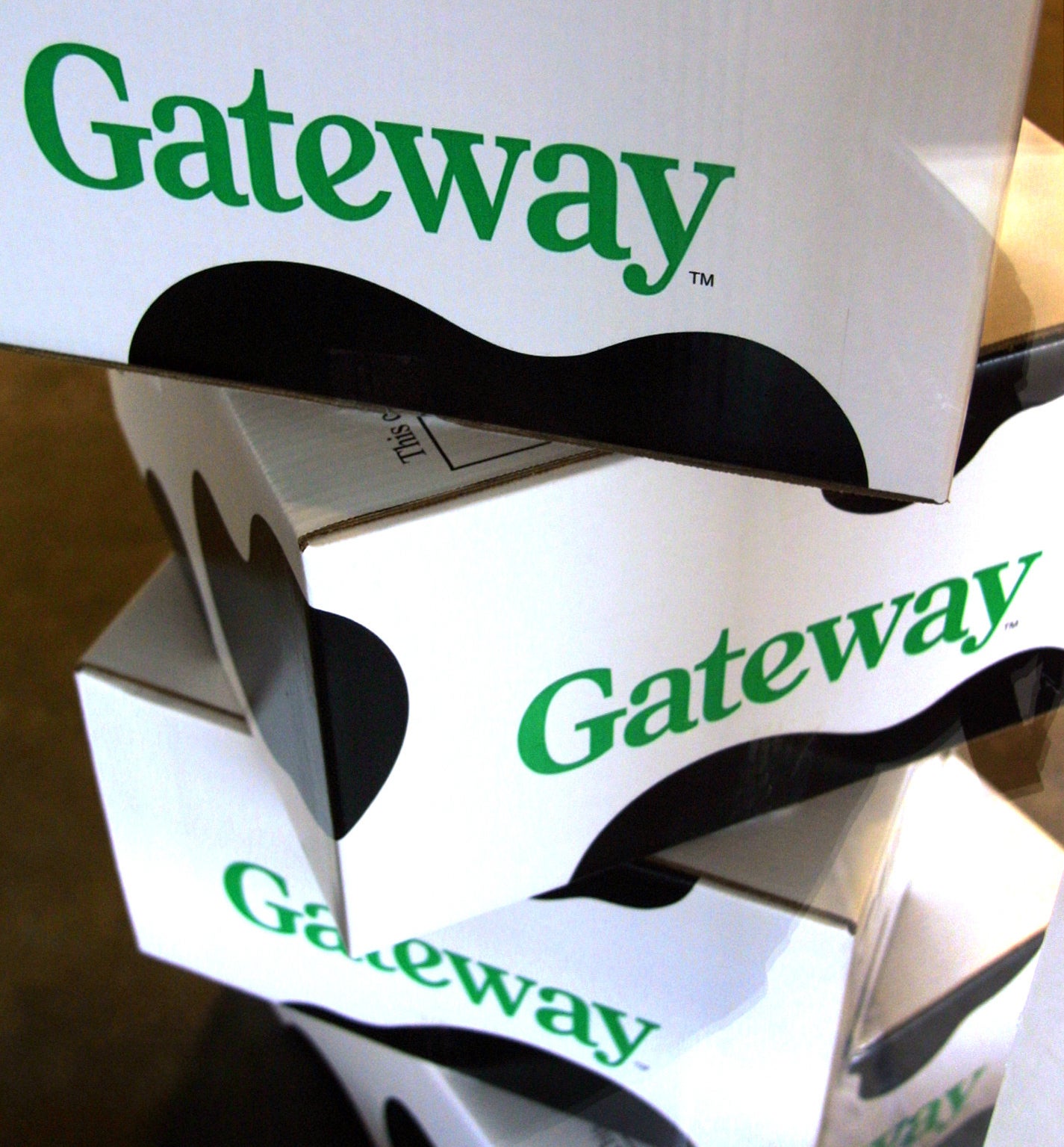 A stack of Gateway computer boxes with cow-print on them