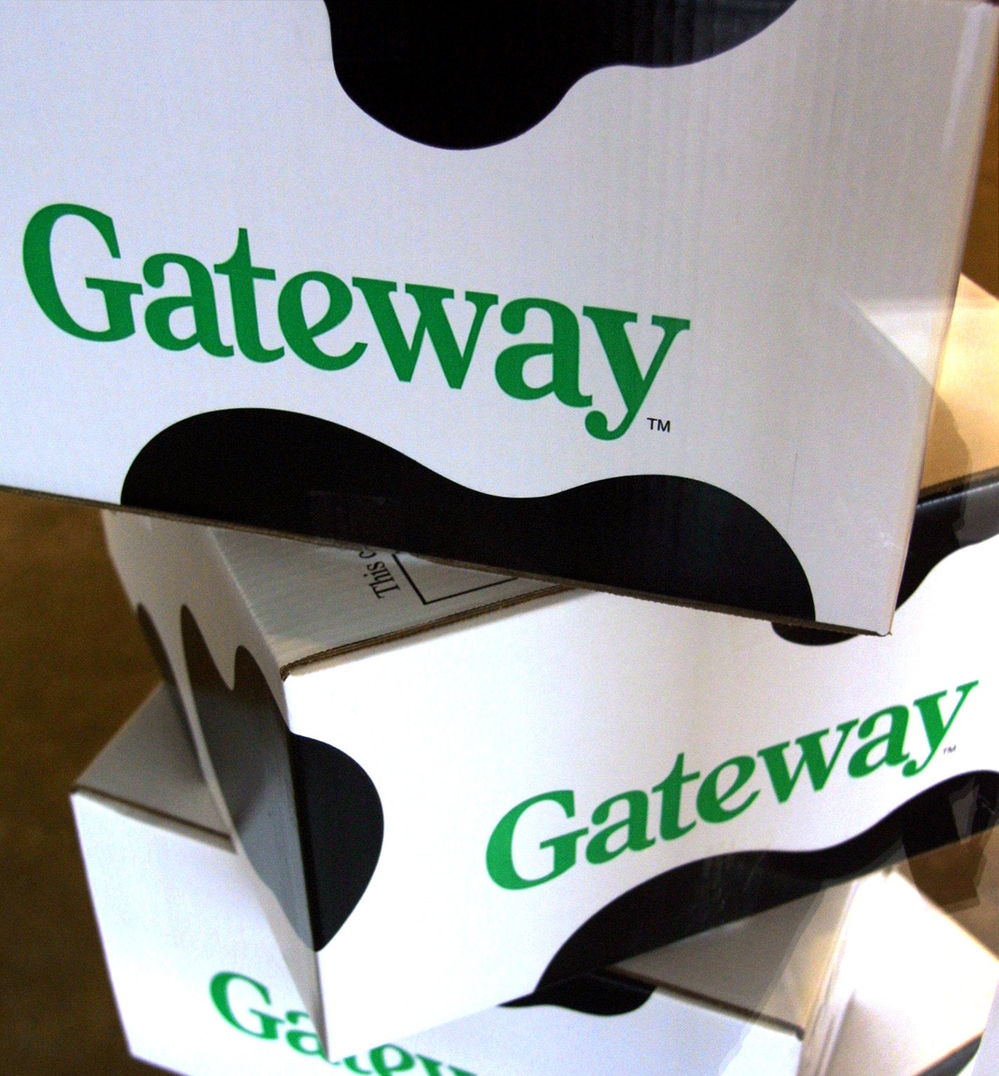 A stack of Gateway computer boxes with cow-print on them