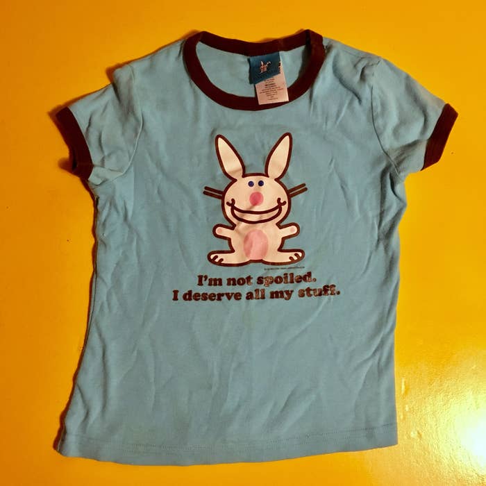 A blue Happy Bunny T-shirt featuring a smiling bunny and &quot;I am not spoiled, I deserve all my stuff&quot;
