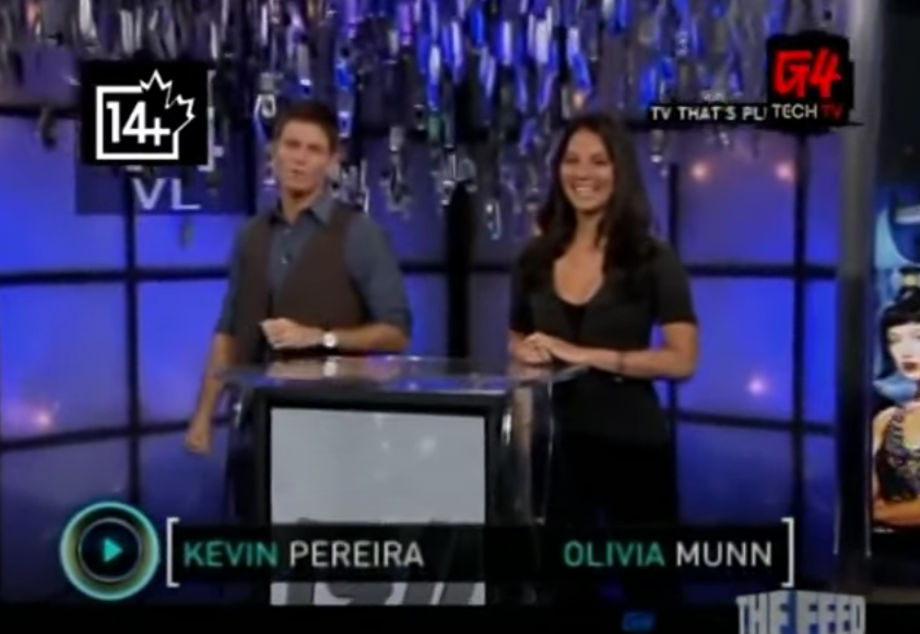 Hosts Kevin Pereira and Olivia Munn standing on the set of &quot;Attack of the Show!&quot;