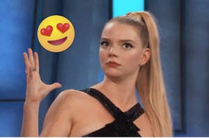 Anya Taylor-Joy with her hand up