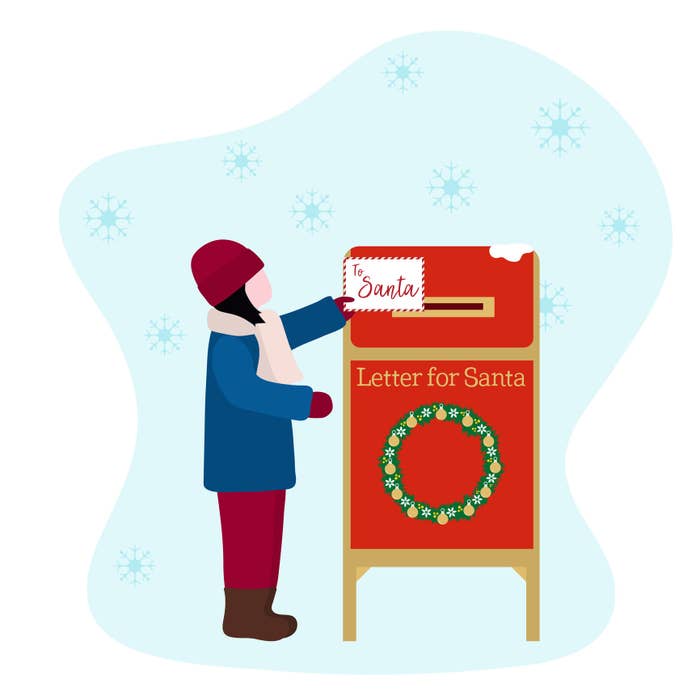 A girl places a letter to Santa into a mailbox 