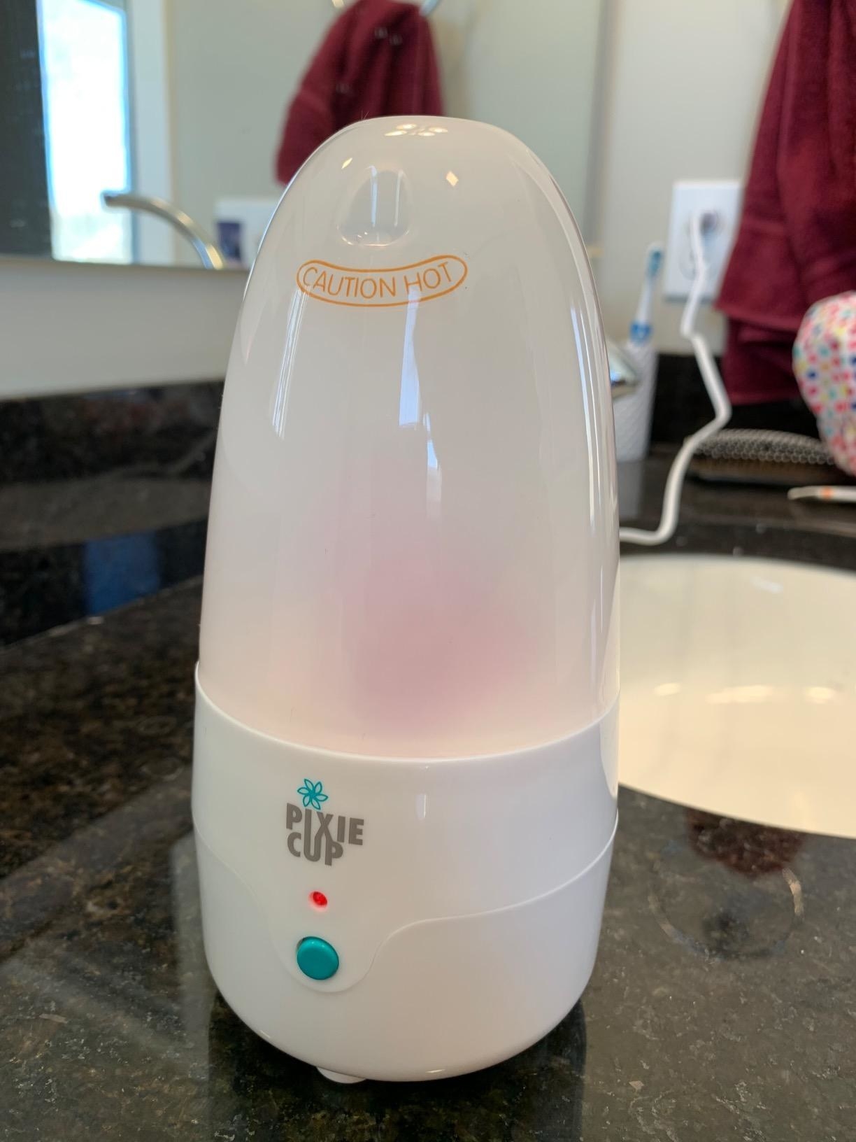 reviewer image of the pixie menstrual cup steamer on a bathroom counter