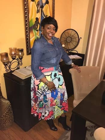 Reviewer wearing the skirt with a brightly colored graphic print of cartoons