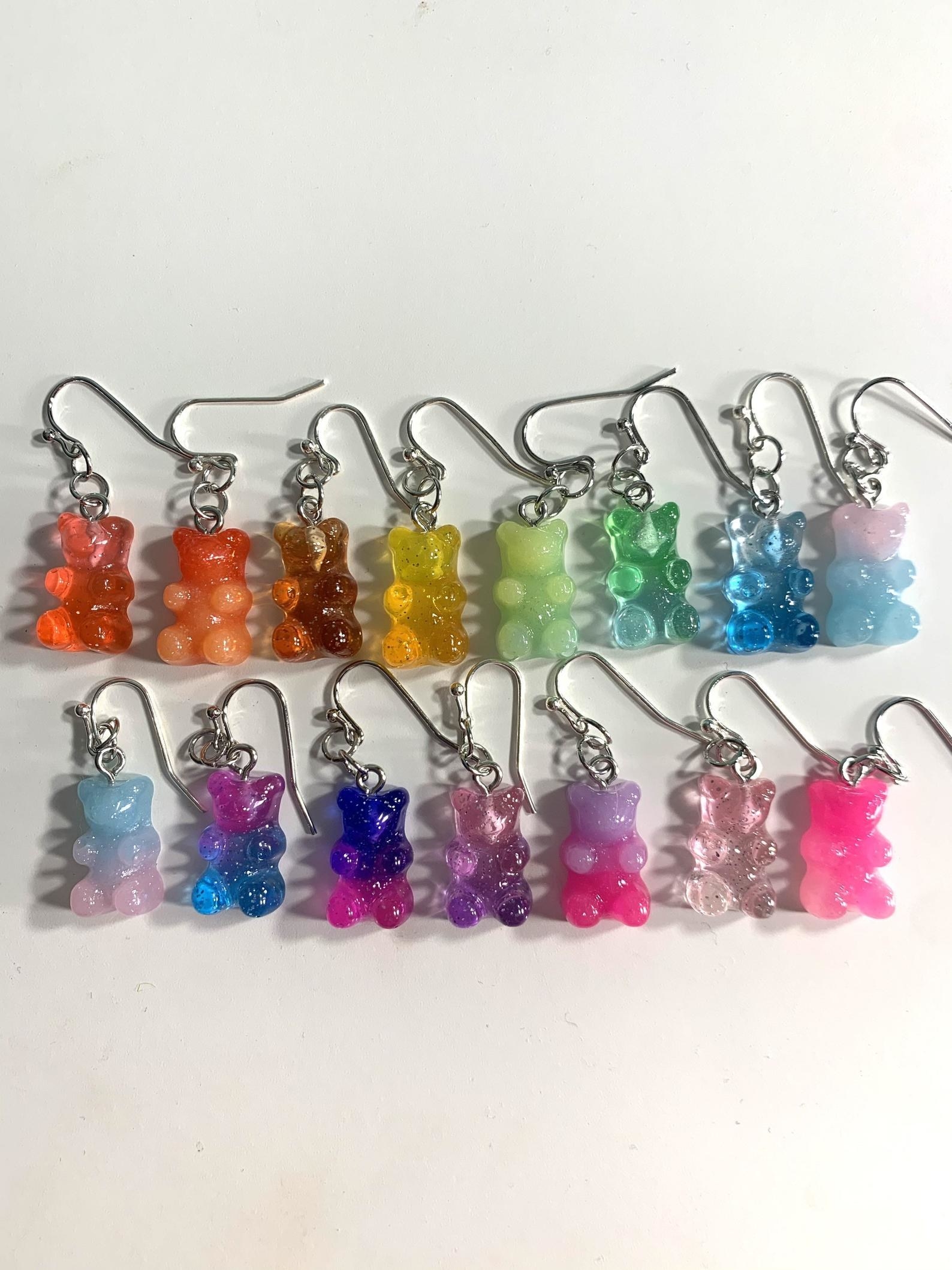 several earrings that are shaped like literal gummy bears in a variety of colors