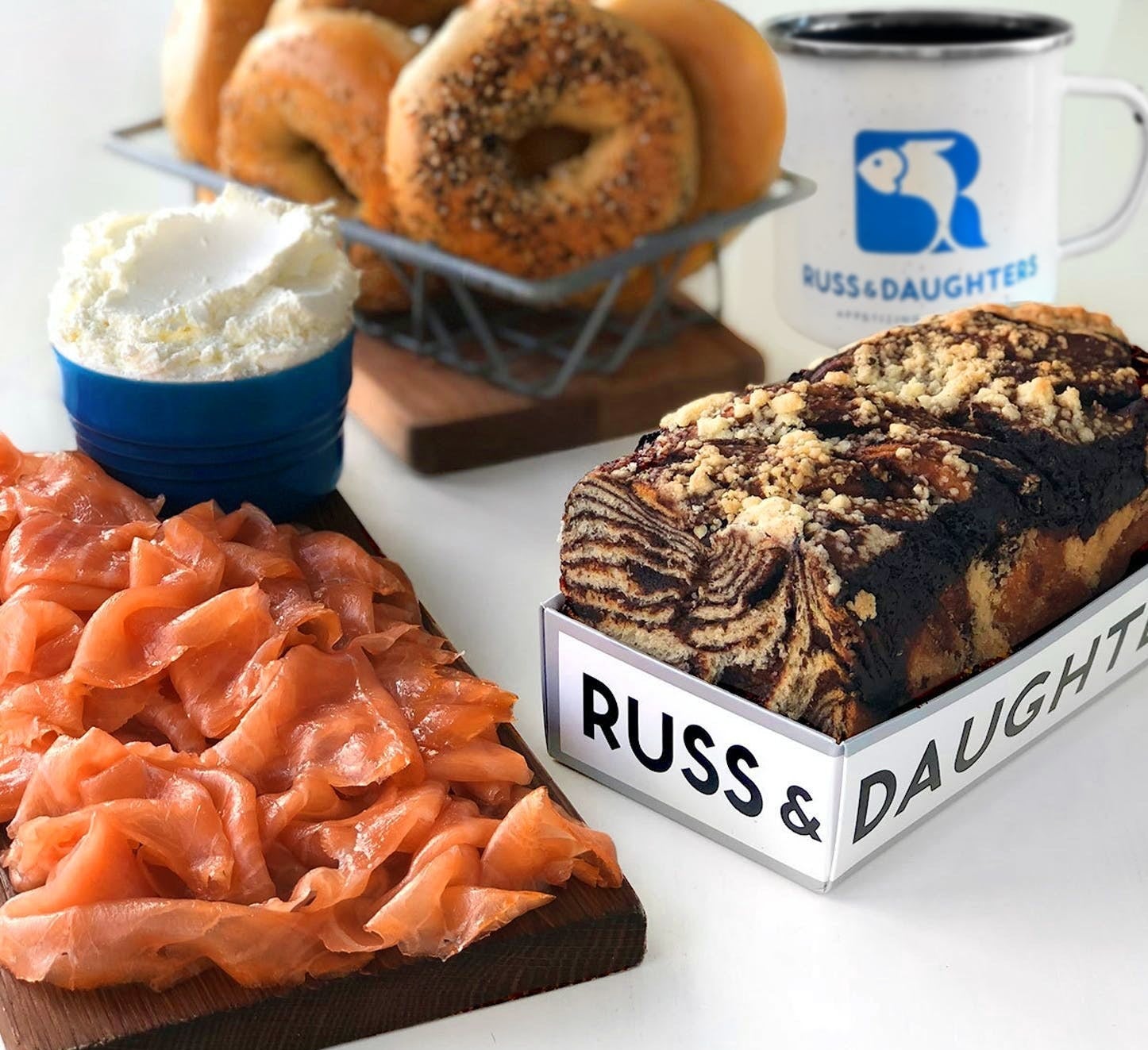 assortment of lox, bagels, cream cheese, coffee, and chocolate babka