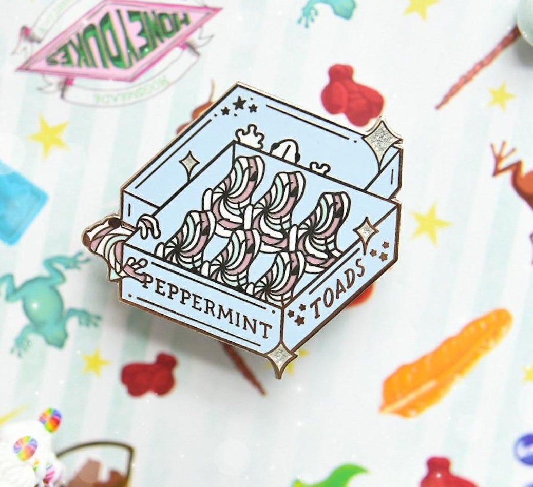 the blue enamel pin with the peppermint toad design 