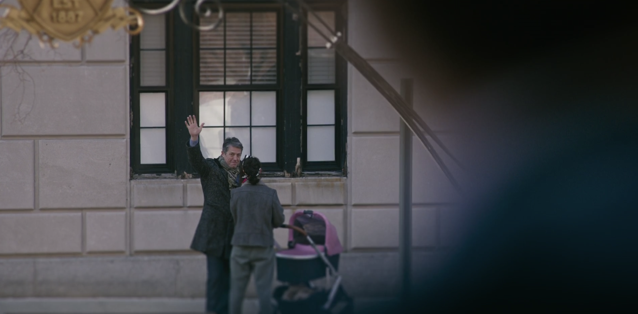 Jonathan waving to Henry while speaking to Elena.