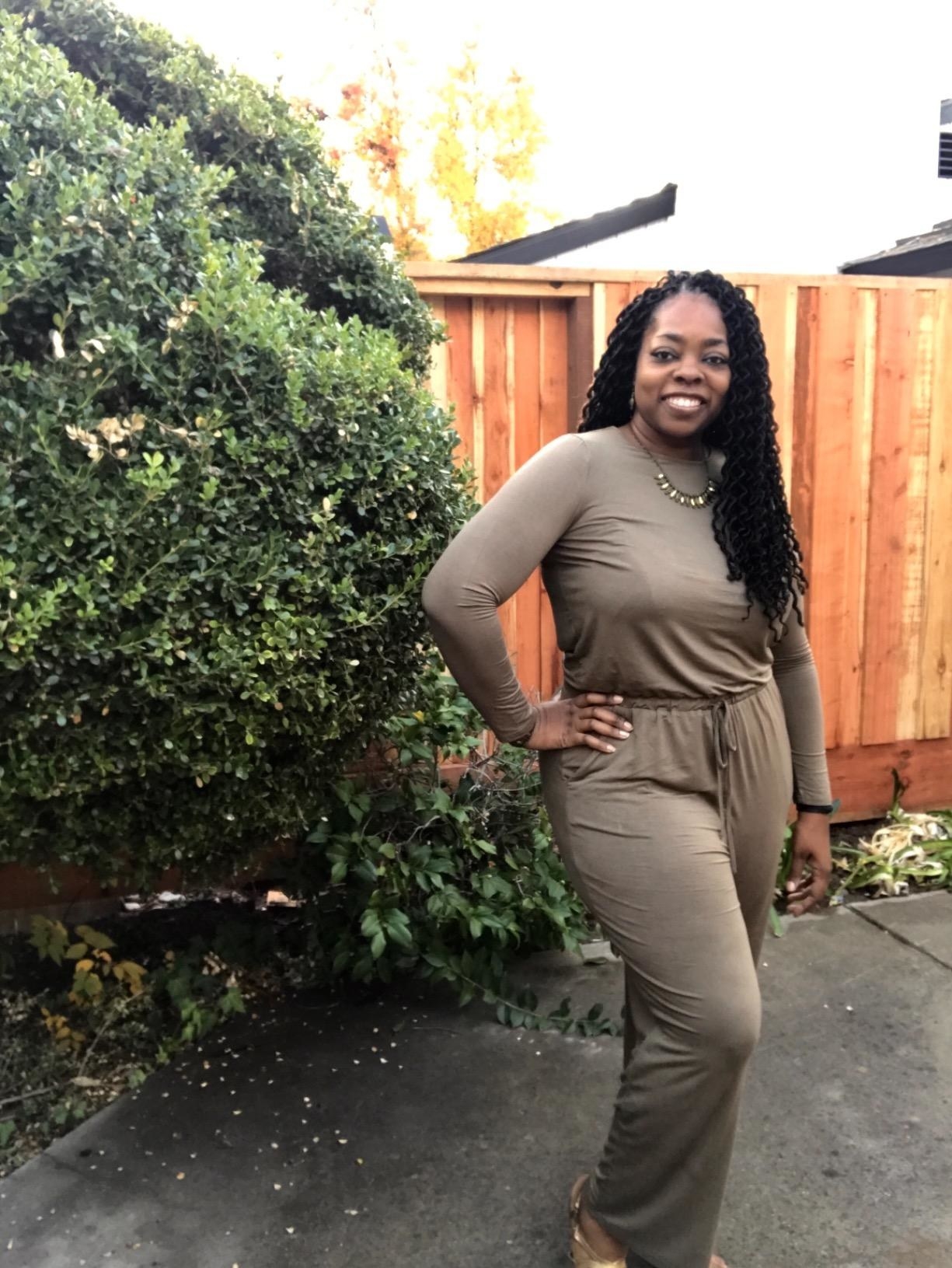 Reviewer wearing the long-sleeved jumpsuit in brown