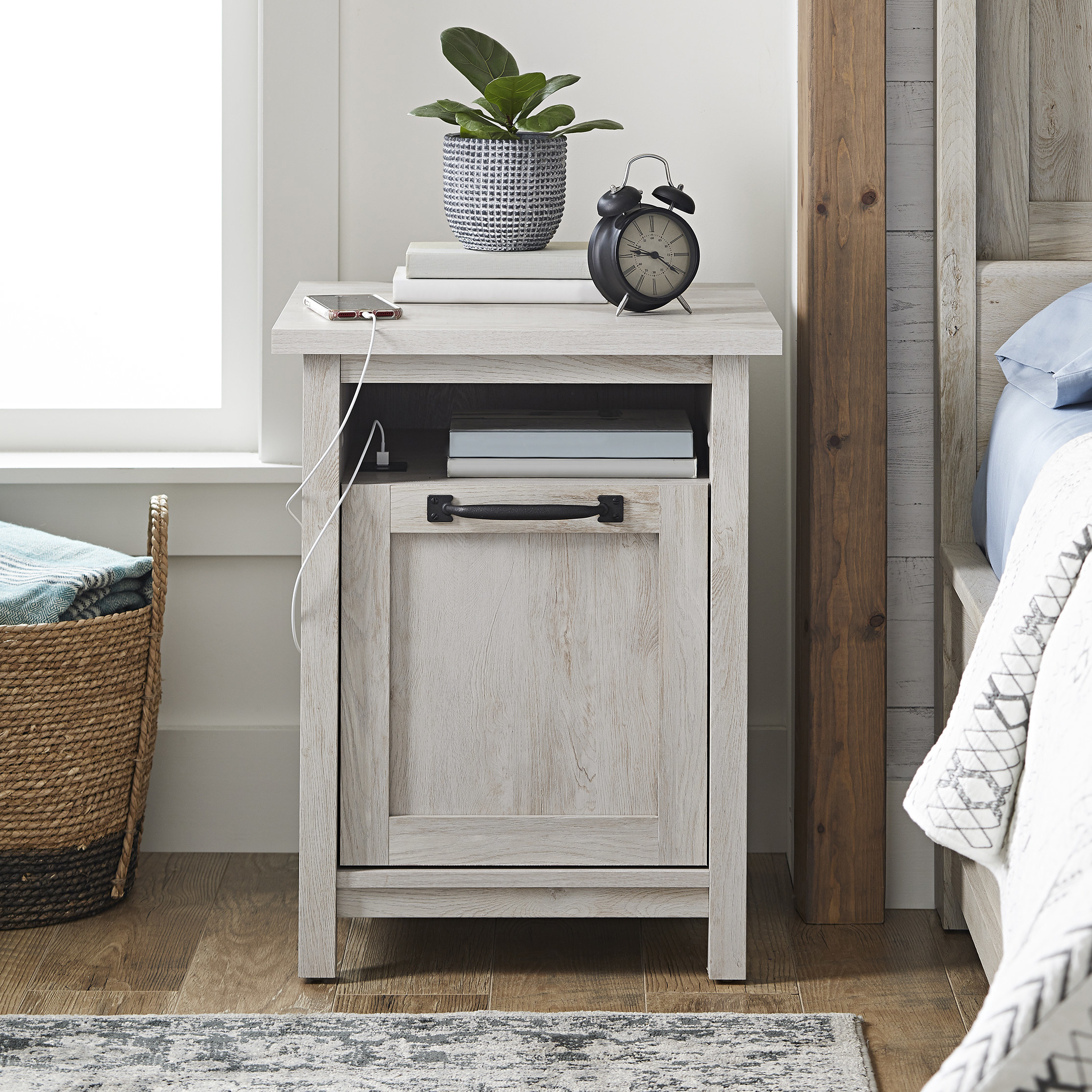 nightstand with a rustic finish and a phone plugged into the USB port