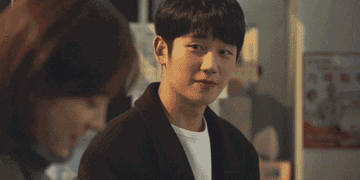 Lee Jeongin glances at Yoo Jiho who is bashfully looking back at her in the K Drama One Spring Night