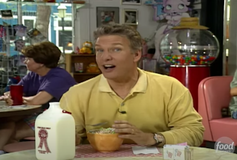 Host Marc Summers eating a bowl of cereal in a dinner
