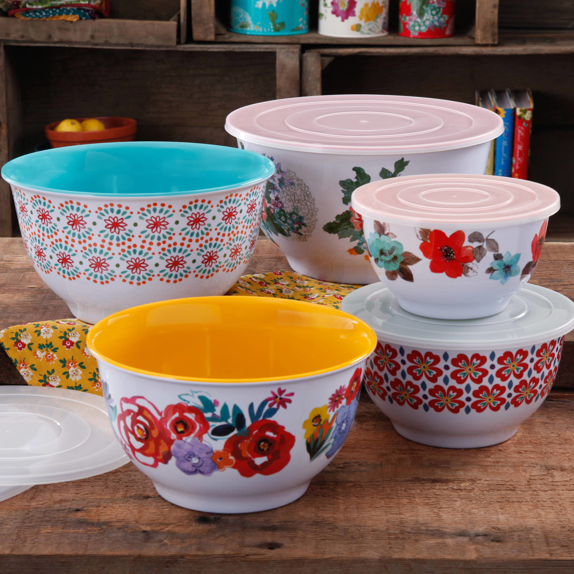 A set of colorful, floral bowls on a wooden counter