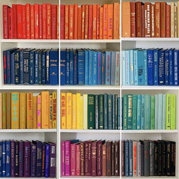 Photo of books on bookshelf organized by color