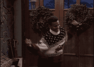 Carlton from Fresh Prince dancing in a holiday sweater 