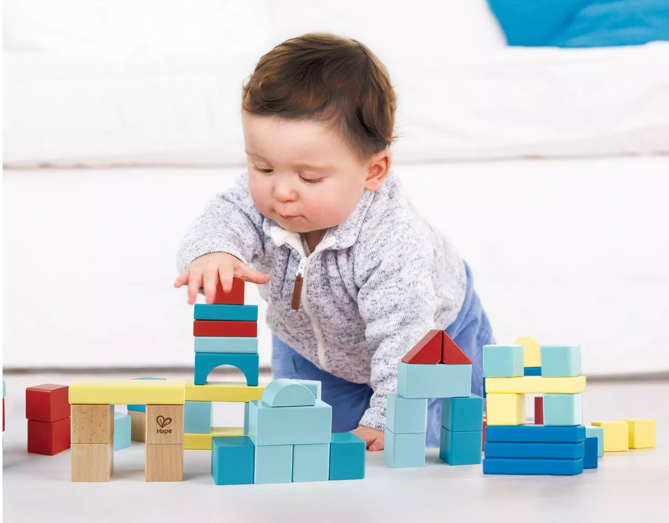 Child model playing with colorful building blocks