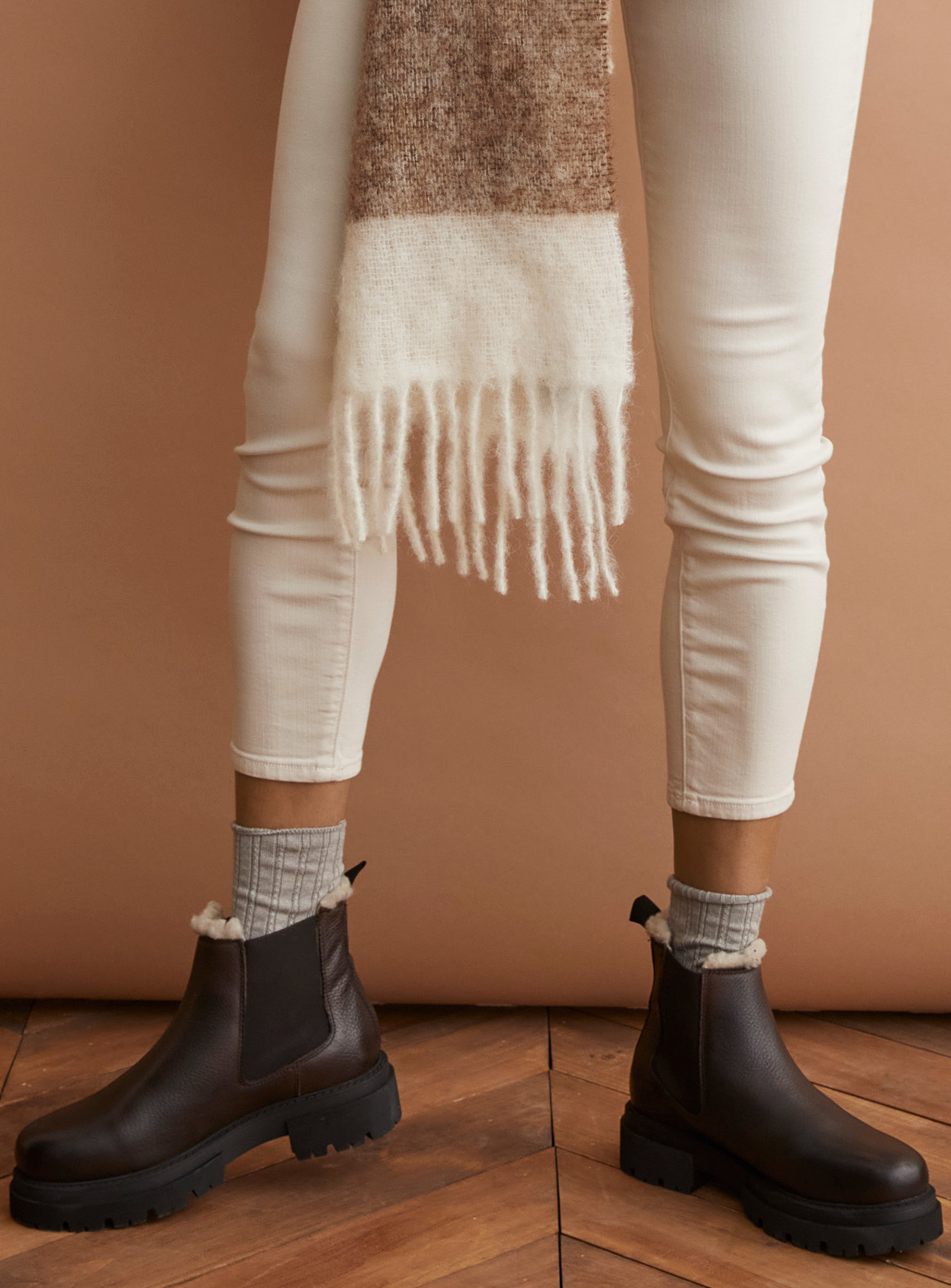 A person wearing leather ankle boots