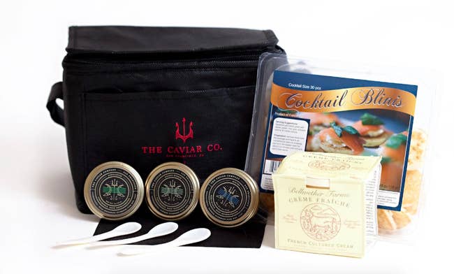 Full caviar kit with three jars, packet of blinis, creme, and carrier bag