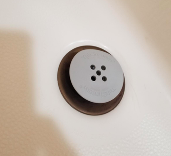 The TubShrom inside of a reviewer's tub drain
