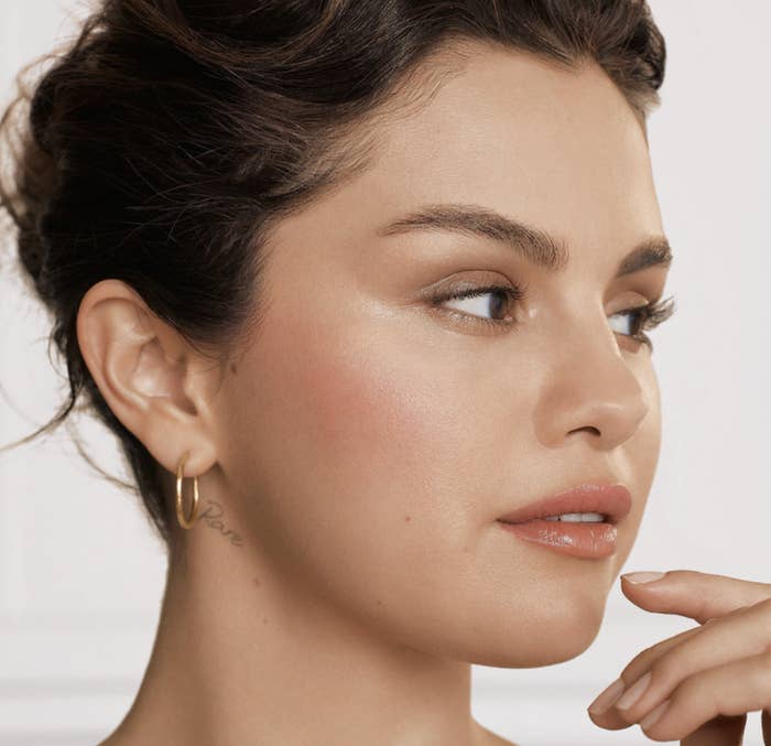 Selena Gomez wearing Positive Light Liquid Luminizer Highlight in radiant finish shade