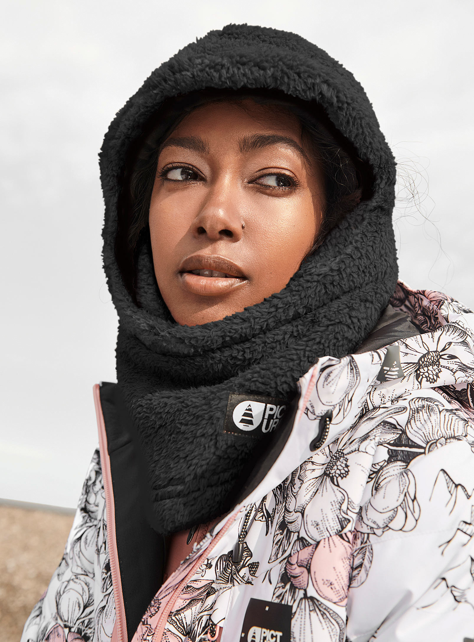 A person wearing a fleece balaclava and winter coat