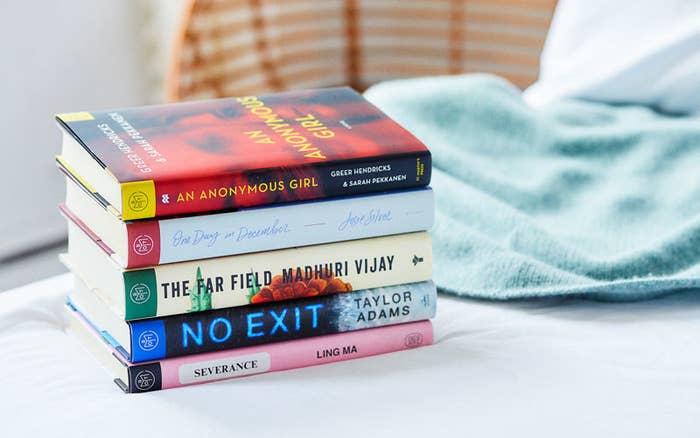 Stack of past Book of the Month titles, including An Anonymous Girl, No Exit, and Severance