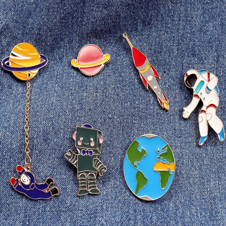 The "space" set: a ringed planet, an astronaut, a rocketship, a robot, the planet earth, and a second ringled planet with a different astronaut dangling beneath it