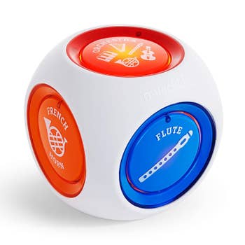 a white music cube with colorful buttons on the sides for each instrument