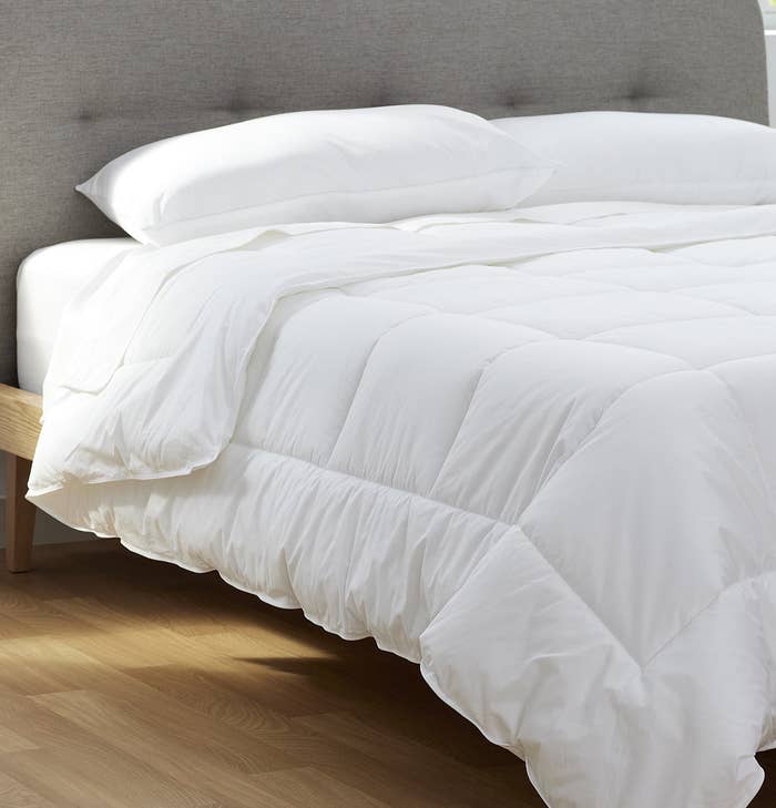 A thick duvet on a bed with two pillows