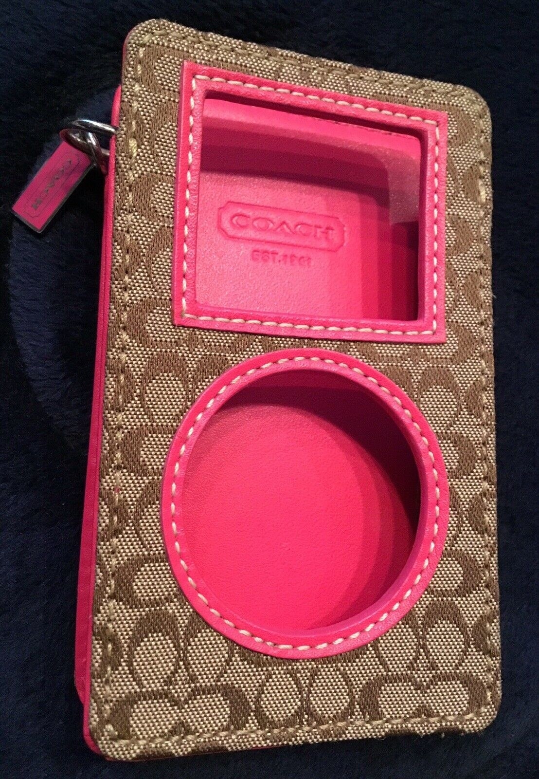 A Coach logo iPod cover with a hot pink leather interior 