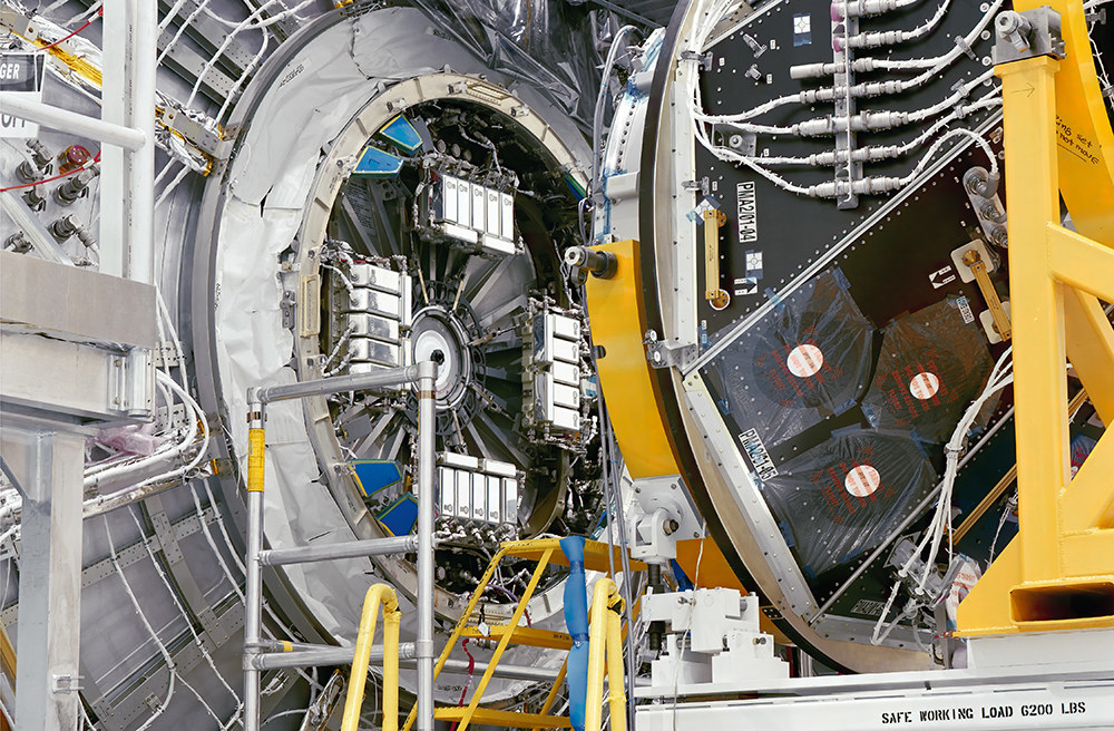 A giant machine about to interlock with another machine, with a ladder in between